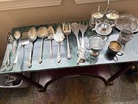 Full view of utensils, tea pieces and small plate on table