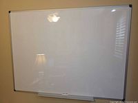 Front view of mounted whiteboard showing full surface, frame, and tray