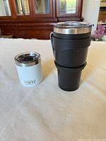 White Yeti lowball next to stacked black tumblers