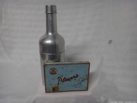 Humidor and cigarette tin side by side