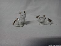 Front view of both miniature dog figurines
