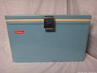 Front view showing Coleman badge, chrome latch, cream trim