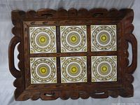 Top view showing full tray, carved frame and six patterned tiles