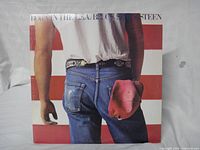 Front of jacket featuring jeans and flag artwork