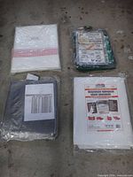 Four packaged tarps laid out