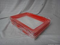 Stack of five red-framed trays sealed in plastic