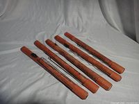 five cylindrical red road flares laid out