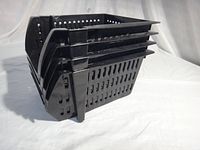Side view of four black plastic baskets nested together