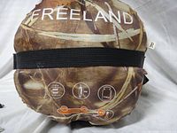 Front of packed sleeping bag showing Freeland branding