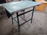 Full view of table showing arborite top and metal frame