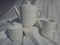 Front view of teapot, creamer and sugar bowl