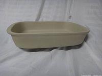Side view of beige stoneware baker