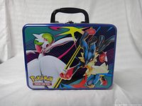 Front view showing Lucario and Gardevoir artwork, latch and handle