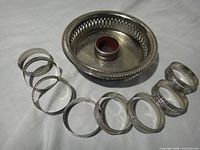 Group view showing coaster, collar inside, and eight napkin rings