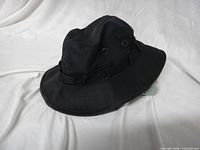 full view of black boonie hat on white background