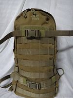 Front of coyote brown Tasmanian Tiger backpack with MOLLE webbing and buckle straps visible