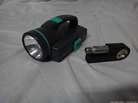 Flashlight and L-shaped hammer/screwdriver handle closed