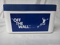 Front of white chest with blue graphic panel "OFF THE WALL" and skateboarder silhouette