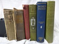 Spines of all six vintage books standing side-by-side