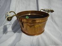 Front side showing copper body, brass handle and ceramic grip