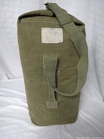 Full view of duffel showing strap, handle, ID patch