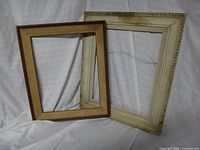 Both vintage wood frames leaning together