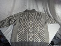 Sweater back showing full pattern and ribbed hem