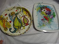 Front view of both trays showing angel and floral designs