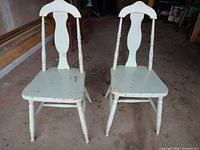 Front view of both chairs showing design and paint wear