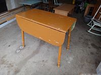 Table with leaves down, showing paint wear