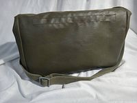 Front view of olive rubberized canvas bag showing plain panel and strap