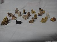 All 19 Wade figurines arranged on white cloth