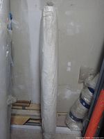 Full view of the sealed poly sheeting roll standing upright