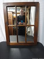 Front view showing six-pane mirror in wooden frame