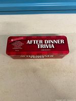 Closed red tin labelled After Dinner Trivia