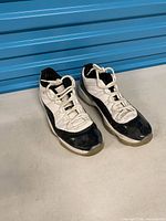 Both sneakers side by side showing overall condition