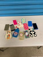 Group shot of all 14 phone cases on table