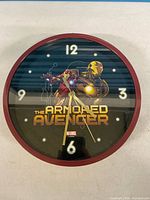 Front view of wall clock showing Iron Man graphic, numerals and hands