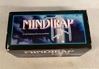 Top view of MindTrap game box showing logo and wear on edges