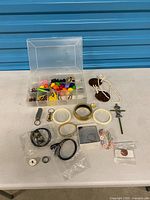 Group shot of organizer box, bracelets, keyrings and accessories on table