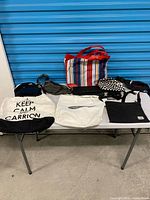 All seven bags arranged on table for overview