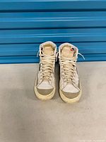 Front view of both shoes showing laces, tongues, toe condition