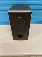 Front view of Sony SS-WS74 subwoofer showing grille and port