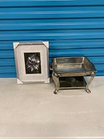 Chafing dish and framed art side by side