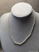 Full view of pearl necklace on display bust