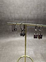 All three pairs of earrings displayed on stand