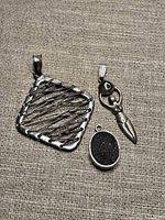 Front view of all three pendants showing design details