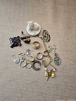 Group shot showing entire mixed jewelry lot and cherub figurine