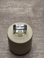 Front view showing PLAY HARD engraving on ring