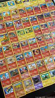 Overview of bulk Pokémon cards laid out showing quantity and variety